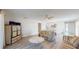 Open-concept living space with wood floors, dining area, and views into the kitchen at 4201 Center Gate Ln # 1, Sarasota, FL 34233