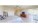 Main bedroom features laminate floors, a ceiling fan, and a sliding glass door to the outside patio at 4201 Center Gate Ln # 1, Sarasota, FL 34233