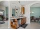 Open-concept kitchen area with wood cabinets, stainless steel appliances and breakfast bar seating at 5311 72Nd E St, Palmetto, FL 34221