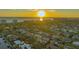 Stunning aerial view of a waterfront community home near the ocean at sunset at 551 Ranger Ln, Longboat Key, FL 34228