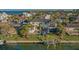 Aerial view of a waterfront home with a pool, private dock, and lush landscaping at 551 Ranger Ln, Longboat Key, FL 34228