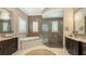 Elegant bathroom featuring double vanities, a soaking tub, and a large glass-enclosed shower at 551 Ranger Ln, Longboat Key, FL 34228
