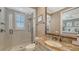 Modern bathroom with glass enclosed shower, granite countertop, and decorative fixtures at 551 Ranger Ln, Longboat Key, FL 34228