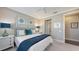 Stylishly decorated bedroom with a large bed, two bedside tables, and adjoining bathroom entrance at 551 Ranger Ln, Longboat Key, FL 34228