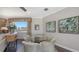 Cozy dining area with glass top table, upholstered chairs, and large window at 551 Ranger Ln, Longboat Key, FL 34228