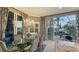Elegant dining room featuring a glass table, chandelier, and sliding doors to an outdoor living space at 551 Ranger Ln, Longboat Key, FL 34228