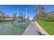 Boat dock on a sunny day, surrounded by palm trees and lush landscaping at 551 Ranger Ln, Longboat Key, FL 34228