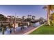 Waterfront boat dock at dusk, showcasing a calm canal with lush vegetation at 551 Ranger Ln, Longboat Key, FL 34228