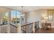 Bright foyer showcasing an iron staircase, dark wood floors, and a scenic waterfront view at 551 Ranger Ln, Longboat Key, FL 34228