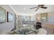 Cozy foyer with a table and chairs, a large arched window, and beautiful neighborhood views at 551 Ranger Ln, Longboat Key, FL 34228