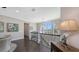Bright hallway features dark wood floors, elegant iron railing, and large arched window offering neighborhood views at 551 Ranger Ln, Longboat Key, FL 34228