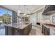 Modern kitchen features an oversized island and convenient access to outdoor living space at 551 Ranger Ln, Longboat Key, FL 34228