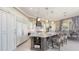 Open kitchen layout features a spacious island with seating, and built in shelving at 551 Ranger Ln, Longboat Key, FL 34228