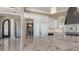 Spacious kitchen with custom cabinets, a large island, and high-end appliances, plus an ornate doorway to the living room at 551 Ranger Ln, Longboat Key, FL 34228