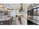 Updated kitchen with a central island, custom cabinetry, and stainless steel built-in appliances at 551 Ranger Ln, Longboat Key, FL 34228