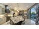 Open kitchen design with an oversized island and sliding doors leading to the patio at 551 Ranger Ln, Longboat Key, FL 34228