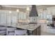 Bright kitchen boasts granite island, custom cabinetry, and stainless steel appliances at 551 Ranger Ln, Longboat Key, FL 34228