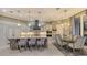 A combined kitchen and dining area includes a large central island and modern pendant lighting at 551 Ranger Ln, Longboat Key, FL 34228