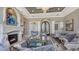 Spacious living room boasts a cozy fireplace, stylish seating, and elegant decor with an ornate doorway at 551 Ranger Ln, Longboat Key, FL 34228