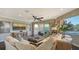 Cozy living room with a large sofa, ottoman, and a view of the water at 551 Ranger Ln, Longboat Key, FL 34228