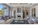 Cozy living room with a fireplace, refined décor, and plenty of seating for entertaining at 551 Ranger Ln, Longboat Key, FL 34228
