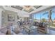 Living room showcases a modern design with an open floor plan connecting to the kitchen and scenic outdoor views at 551 Ranger Ln, Longboat Key, FL 34228