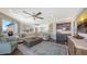 Bright living room featuring a wet bar, plush seating, and a decorative rug, perfect for entertaining at 551 Ranger Ln, Longboat Key, FL 34228