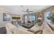 Comfortable living room with large sectional sofa and sliding glass doors to balcony at 551 Ranger Ln, Longboat Key, FL 34228