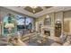 Elegant living room featuring a fireplace, coffered ceiling, and large windows with scenic outdoor views at 551 Ranger Ln, Longboat Key, FL 34228