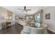 Open-concept living area with a dining nook, comfortable seating, and natural light from the windows at 551 Ranger Ln, Longboat Key, FL 34228