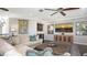 Bright living room featuring a comfortable sofa, ceiling fan, and decorative artwork at 551 Ranger Ln, Longboat Key, FL 34228