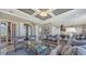 Elegant living room with a grand entrance, coffered ceiling, and seamless flow into the modern kitchen at 551 Ranger Ln, Longboat Key, FL 34228