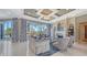 Bright and airy living room with luxury finishes, beautiful window views, and cozy fireplace at 551 Ranger Ln, Longboat Key, FL 34228