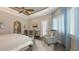 Spacious main bedroom with sitting area, a tray ceiling, exterior access, and walk-in closet at 551 Ranger Ln, Longboat Key, FL 34228