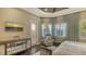 Bright main bedroom with shuttered windows, a mirrored dresser, and comfortable seating at 551 Ranger Ln, Longboat Key, FL 34228