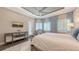 Serene main bedroom with tray ceiling, plantation shutters, blue accents, and a mirrored dresser at 551 Ranger Ln, Longboat Key, FL 34228