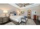 Comfortable main bedroom with tray ceilings, bedside tables, and ensuite bathroom entrance at 551 Ranger Ln, Longboat Key, FL 34228