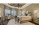 Spacious main bedroom with a sitting area, wood floors, tray ceiling, and natural light at 551 Ranger Ln, Longboat Key, FL 34228
