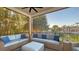 Screened patio with comfortable seating and beautiful landscaping offers a relaxing outdoor space at 551 Ranger Ln, Longboat Key, FL 34228
