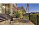 Cozy patio with a fire pit, comfortable seating, and lush landscaping, perfect for outdoor gatherings at 551 Ranger Ln, Longboat Key, FL 34228