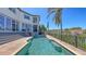 Backyard pool with patio, landscaping, fence, and beautiful views of tropical foliage at 551 Ranger Ln, Longboat Key, FL 34228