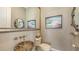 Unique powder room with a stone sink, decorative mirror, and stylish fixtures at 551 Ranger Ln, Longboat Key, FL 34228
