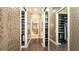 Spacious walk-in closet with built-in shelving and mirrors providing ample storage space at 551 Ranger Ln, Longboat Key, FL 34228