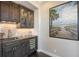 Wet bar has granite countertops, a beverage cooler, custom cabinets, and a decorative backsplash at 551 Ranger Ln, Longboat Key, FL 34228
