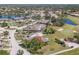 Spectacular aerial view showcases the property's proximity to a lush golf course and lake at 5604 Doral Dr, Sarasota, FL 34243