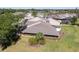 A scenic aerial view of a well-maintained home featuring an outdoor patio and lush green landscaping at 5604 Doral Dr, Sarasota, FL 34243
