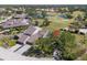 Beautiful aerial view of a home on a golf course with scenic water features at 5604 Doral Dr, Sarasota, FL 34243
