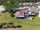 An aerial view of a home featuring screened lanai, patio and well-manicured lawn at 5604 Doral Dr, Sarasota, FL 34243