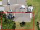 Bird's eye view of a home featuring a screened patio and beautifully landscaped yard at 5604 Doral Dr, Sarasota, FL 34243