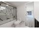 Bathroom featuring a tub with marble surround and glass enclosure at 5604 Doral Dr, Sarasota, FL 34243